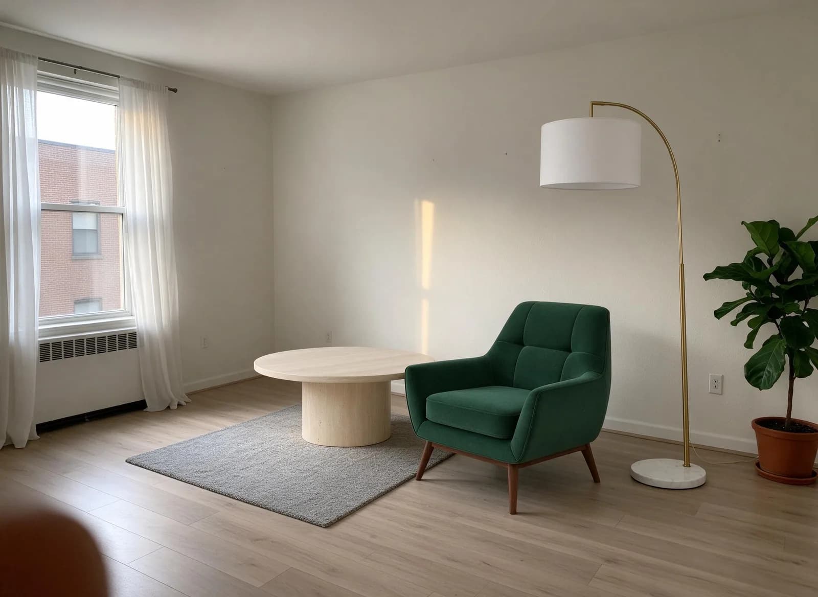 The same living room with the velvet armchair, travertine coffee table and brass arc floor lamp placed in it